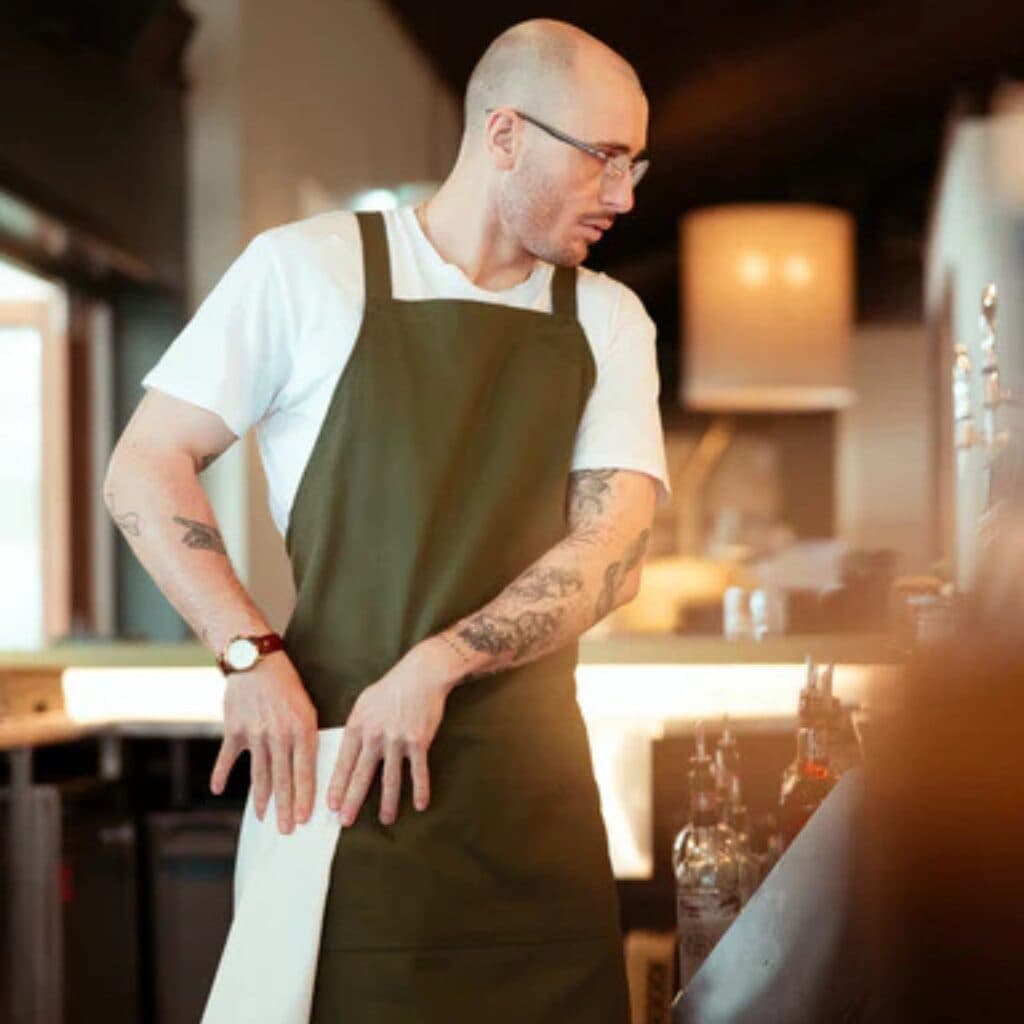 Bulk restaurant merch manufacturer for branded tees and aprons