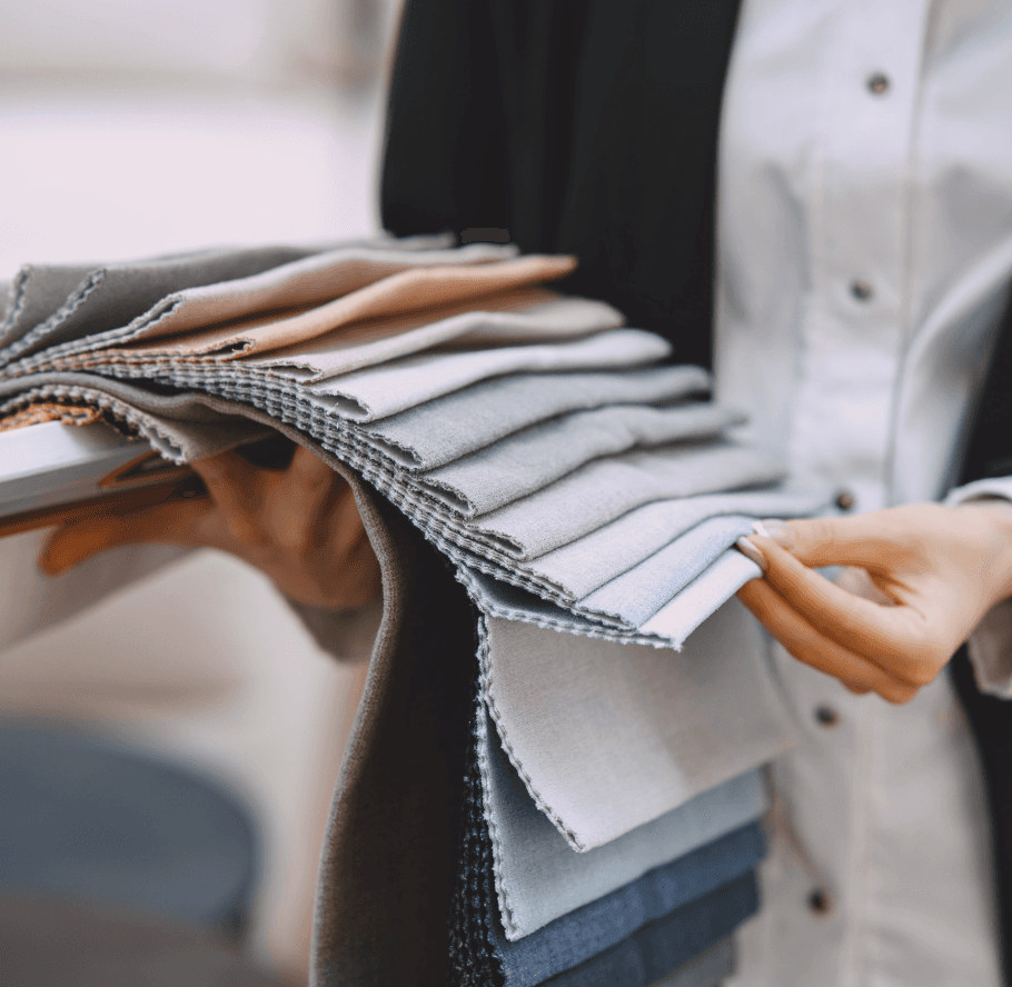 Nevear textile specialist holding a palette of custom apparel fabric swatches