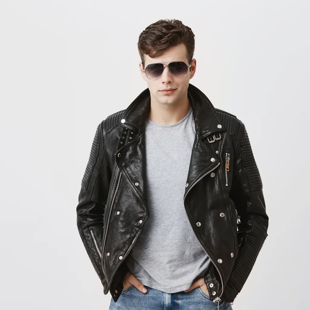 Man in sunglasses wearing a black leather biker jacket over a grey t-shirt