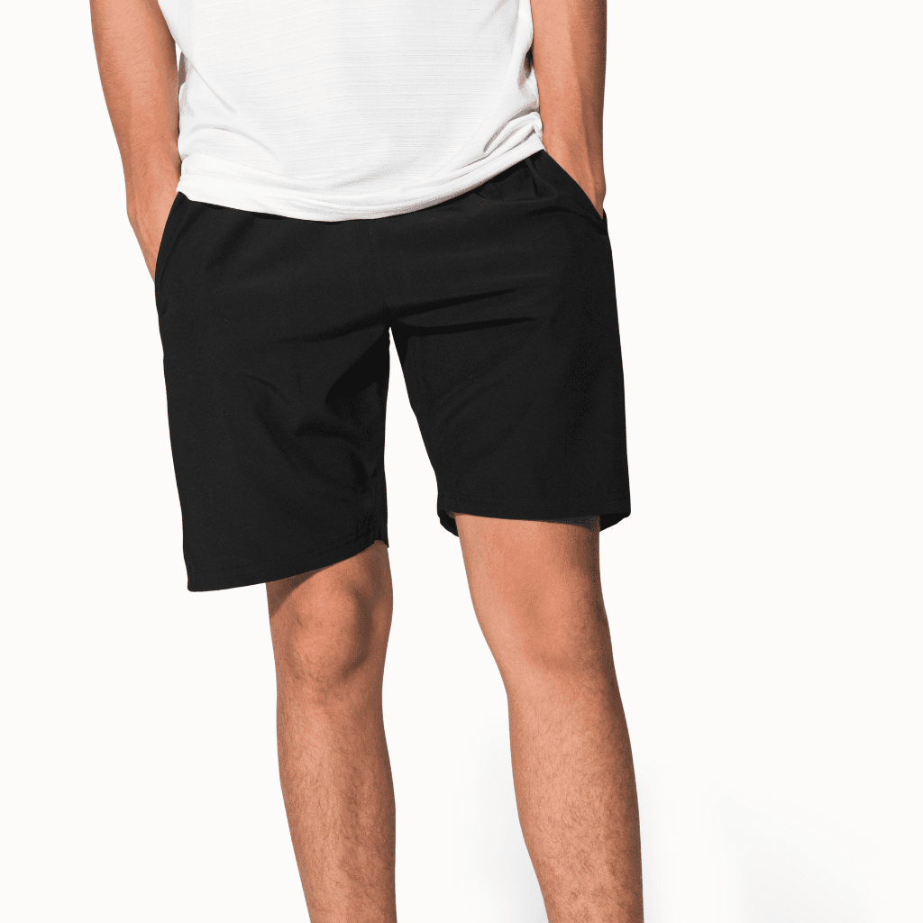 Close-up of a man in a white t-shirt and black cotton shorts