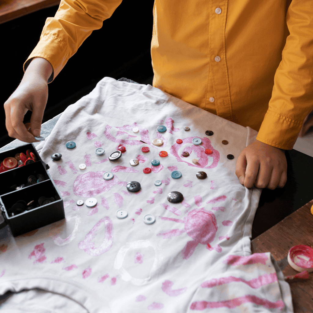 Crafting custom buttons and artistic embroidery details on personalized t-shirt